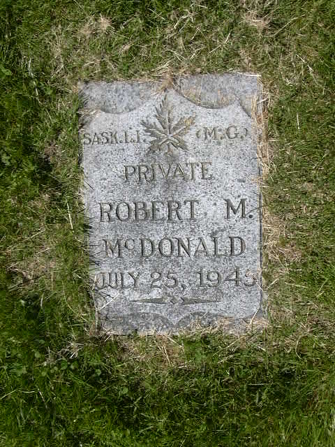 Gravestone of Private Robert M. McDonald, dated July 25, 1945, stands in the grass as a tribute to resilience. Inscriptions "SASK. L.I." and "M.G." echo his legacy, reminding the community annually on Remembrance Day of the sacrifices made.