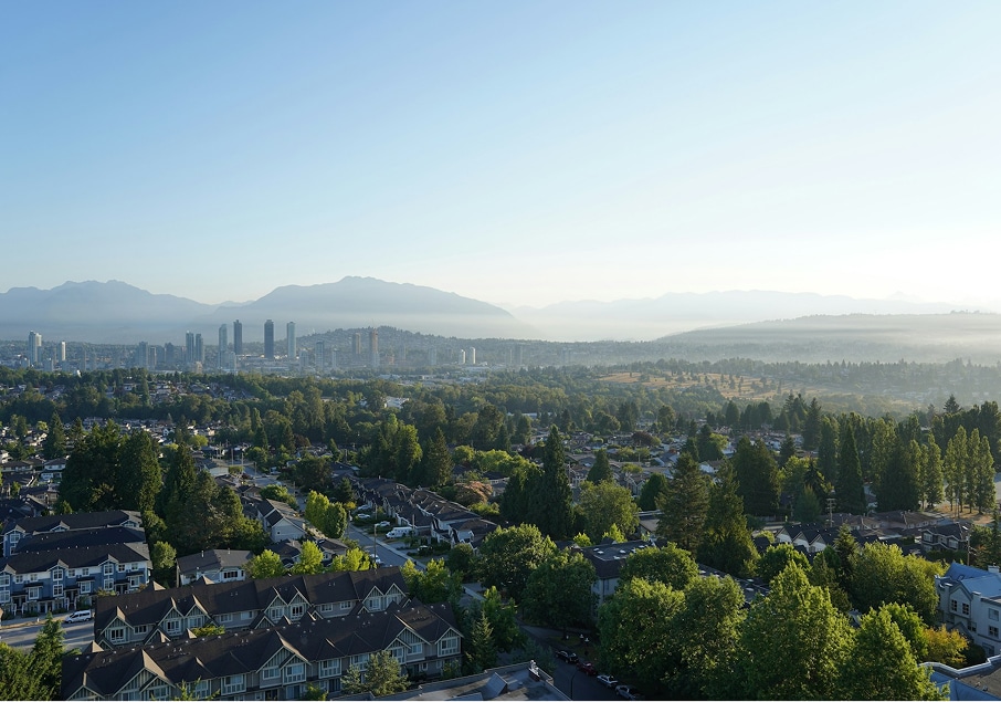 BBX Moving | Warehouse Movers – North Vancouver - View of a suburban Burnaby neighborhood with houses, trees, and distant city buildings under a clear sky, with mountains visible in the background—perfect for those seeking reliable warehouse movers nearby. View of a suburban Burnaby neighborhood with houses, trees, and distant city buildings under a clear sky, with mountains visible in the background—perfect for those seeking reliable warehouse movers nearby.