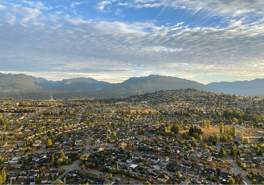 BBX Moving | Office Movers – Vancouver - Aerial view of a suburban Burnaby neighborhood with houses, scattered trees, and distant mountains—an ideal setting for Office Movers seeking a peaceful yet accessible location under a partly cloudy sky. Aerial view of a suburban Burnaby neighborhood with houses, scattered trees, and distant mountains—an ideal setting for Office Movers seeking a peaceful yet accessible location under a partly cloudy sky.